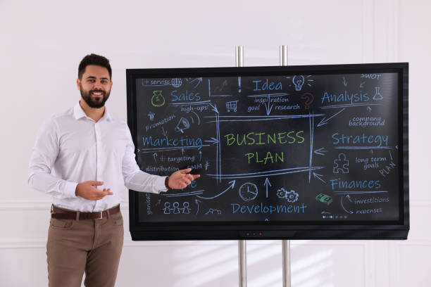 Business trainer using interactive board in meeting room